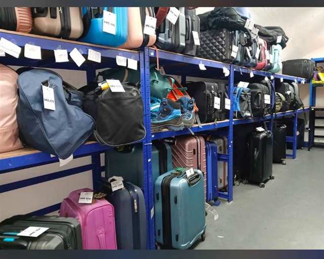 Luggage stored safely on blue shelving